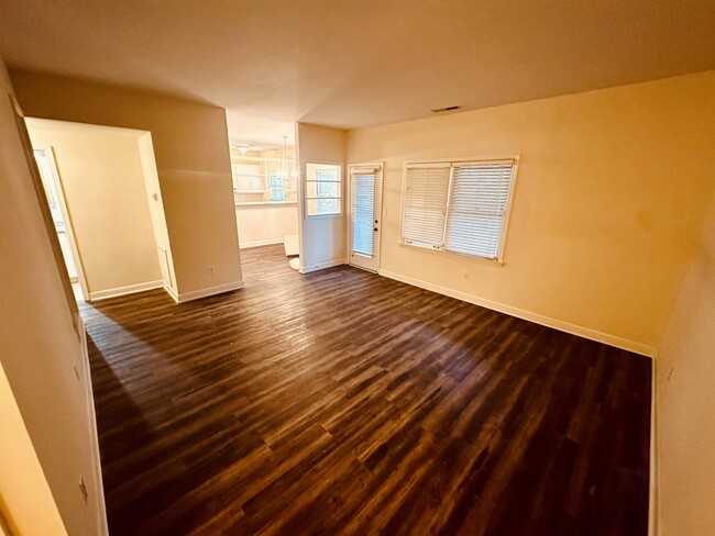 Large living space that leads to dining room, balcony and bedrooms - 245 Willow Ct