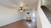 This well-designed two-story home in Terrell, TX offers 920 square feet of comfortable living space. The layout includes 2 bedrooms, 2 bathrooms, a kitchen, living room, hallway, and closet space spread across two floors. The ground floor encompasses 440 square feet, while the upper level provides 480 square feet.

The heart of the home is the open-concept kitchen and living area. The kitchen features dark wood cabinetry contrasting with white appliances and a convenient built-in desk area. Rich wood-look flooring flows throughout the main living spaces, creating a warm and inviting atmosphere.

Large windows in the living room and bedrooms allow ample natural light to fill the space. The primary bedroom, measuring 160 square feet, offers a spacious retreat with plush carpeting and a ceiling fan for comfort. The second bedroom also provides a cozy space with similar amenities.

Both bathrooms are functionally designed with modern fixtures and include shower/tub combinations. The home's neutral color palette and clean lines create a fresh, contemporary feel throughout. With its efficient use of space and thoughtful design, this home offers a comfortable and practical living environment.