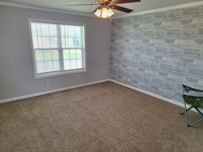 Living room with accent wall, ceiling fan - 695 Artic Ave
