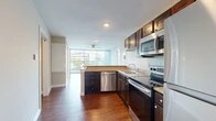Located at 1846 Fairfield Ave in Shreveport, Louisiana, this well-appointed two-bedroom, two-bathroom residence offers a thoughtfully designed single-level layout. Rich hardwood-style flooring flows consistently throughout the home, lending warmth and continuity to every room. The open-concept kitchen is a standout feature, equipped with a full suite of stainless steel appliances — including a range, microwave, dishwasher, and refrigerator — complemented by dark espresso cabinetry, granite-look countertops, and a classic subway tile backsplash. The kitchen transitions seamlessly into the combined dining and living area, where large sliding glass doors and expansive windows flood the space with natural light and provide open views of the surrounding cityscape and greenery. A ceiling fan adds comfort to the living area. The generously sized primary bedroom offers ample room, with access to a walk-in closet featuring wire shelving. Both bathrooms are finished with dark wood vanities, white countertops, and walk-in showers with chrome fixtures. With four closets throughout, storage is plentiful. The overall ambiance is clean, bright, and modern, making this a functional and comfortable urban residence.