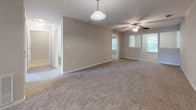 Located at 2109 Oglethorpe Circle in Pooler, Georgia, this single-story home offers a practical and comfortable layout throughout. A tiled entryway hallway leads into the main living areas, where plush carpeting extends across spacious rooms fitted with ceiling fans for year-round comfort. Natural light filters in through multiple windows, lending a bright and welcoming ambiance to each space.

The kitchen is equipped with rich, dark wood cabinetry offering ample upper and lower storage, light-toned countertops, a white electric range, and a full-size refrigerator, all set atop easy-to-maintain tile flooring. The open flow from the hallway into the main living area makes the home feel connected and functional.

Multiple carpeted bedrooms provide comfortable retreats, each featuring windows that bring in natural light and views of the surrounding neighborhood. The home includes several bathrooms, each finished with dark wood vanities, white countertops, and tile flooring. Bathroom configurations include both a tub-shower combination and a standalone walk-in shower, catering to a variety of preferences. The neutral color palette and clean finishes throughout the home create a move-in-ready environment well-suited for everyday living in the Pooler community.