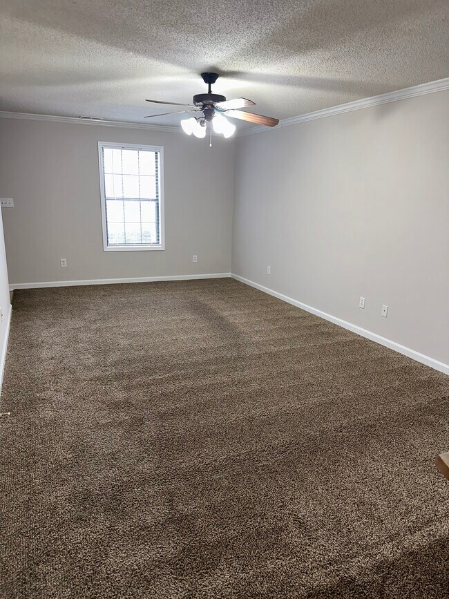 Spacious living room with carpet. - 1211 Goldridge Dr SW