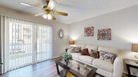 This well-appointed one-bedroom, one-bathroom residence in Chesterfield, MO offers a thoughtfully organized single-floor layout with a warm, comfortable ambiance throughout. The living room serves as the heart of the home, showcasing wood-style plank flooring, a ceiling fan with light fixture, a classic fireplace with a white mantel, and a sliding glass door that opens to a private balcony, allowing natural light to fill the space. Adjacent to the living area, the dining room features chair-rail molding and hardwood-style flooring, creating an elegant yet casual setting for meals. The kitchen is designed with a peninsula breakfast bar, dark granite-style countertops, warm wood cabinetry, stainless steel appliances, and a smooth flow into the main living and dining areas. The spacious primary bedroom is carpeted for comfort and includes a large window with sheer drapes, a textured ceiling, and access to a dedicated closet. The full bathroom offers wood-style flooring, a wide vanity with generous counter space, warm cabinetry, a large mirror, and a tub-shower combination. Textured ceilings are consistent throughout the residence, adding a classic architectural detail to every room.