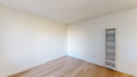 Located at 1241 East Madison Avenue in El Cajon, CA, this one-bedroom, one-bathroom unit offers a well-organized layout across a single floor. Light wood flooring runs throughout the entire space, giving it a clean, cohesive appearance that enhances the overall brightness.

The open-concept living, dining, and kitchen area serves as the heart of the unit. The kitchen is equipped with white cabinetry featuring modern hardware, a stainless steel refrigerator, and a sink with contemporary fixtures — all finished with a crisp, minimalist aesthetic. Natural light enters through a large window in the living area, which also includes a wall-mounted HVAC unit for year-round climate control.

The bedroom is a comfortable, well-proportioned room featuring light-filled windows with vertical blinds and a sliding-door closet that provides ample storage. The textured white ceilings and neutral wall tones carry throughout, maintaining a consistent, airy feel.

The bathroom is finished in white tile, featuring a full tub/shower combination with chrome fixtures, a white vanity with gold-toned hardware, and a frosted window that allows natural light while ensuring privacy.

A hallway connects the rooms efficiently, completing a functional and neatly designed layout suited for comfortable everyday living.