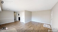 Located at 1829 Front St in Durham, NC, this single-floor, 2-bedroom, 2-bathroom residence offers a well-organized layout with consistent wood-look flooring and neutral tones throughout. The living room is bright and open, benefiting from large windows and a sliding glass door that invites natural light and provides access to an outdoor patio area. The kitchen is thoughtfully updated with white shaker-style cabinetry, a mosaic tile backsplash, stainless steel appliances including a refrigerator and dishwasher, and durable wood-look flooring that ties the space together. Both bedrooms are comfortably sized, with the primary bedroom offering direct access to its own bathroom, providing added privacy. The second bedroom features mirrored sliding closet doors that enhance the sense of space. The two bathrooms are functional and clean — one includes a vanity with a white countertop and a lighted mirror, while the other features a full tub-shower combination with grab bars. A dedicated in-unit laundry area with a full-size washer and dryer adds everyday convenience. The overall ambiance is clean, neutral, and move-in ready, making efficient use of the available floor space.