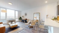 Located at 150 Main St in Hackensack, NJ, this modern single-floor residence offers a thoughtfully designed layout that balances comfort and contemporary style throughout. The open-concept living and dining area is anchored by light wood-tone flooring and crisp white walls, creating a bright and airy atmosphere. Large windows flood the space with natural light and frame urban views of the surrounding cityscape, enhancing the sense of openness. The living area features clean lines and a welcoming layout, while the adjacent dining space provides ample room for entertaining. The kitchen is outfitted with dark charcoal cabinetry, light quartz countertops, a white subway tile backsplash, and a full suite of stainless steel appliances, including a refrigerator, range, and over-the-range microwave. A peninsula counter adds additional workspace and separates the kitchen from the entryway. The bedroom is a serene retreat with a large window offering exterior views, light hardwood-style flooring, and generous closet space with floor-to-ceiling white cabinetry. The bathroom is finished with marble-style tile flooring, a dark vanity with a white countertop, a full tub with white subway tile surround, and a well-lit vanity mirror. Throughout the residence, the design emphasizes clean, modern finishes and functional living spaces.