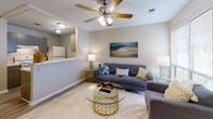 Located at 1004 Appomattox Ct in Fayetteville, NC, this single-floor residence offers a well-designed layout that balances functionality and comfort throughout its living spaces.

The kitchen is equipped with gray cabinetry, a white electric range, a full-size refrigerator, and a built-in sink set into a peninsula counter that opens directly to the living area. The wood-look flooring in this zone adds warmth and is easy to maintain.

The living room is bright and welcoming, featuring a ceiling fan with light fixture, neutral walls, and a large window fitted with blinds that allows natural light to fill the space. The open sightline to the kitchen enhances the sense of connected, functional living.

The bedroom is carpeted for comfort and includes a ceiling fan, a standard closet with sliding doors, and a window overlooking the outdoors. The room offers a calm, restful atmosphere with ample space for furnishings.

The bathroom is cleanly appointed with a vanity featuring a white countertop, an undermount sink, under-vanity cabinetry, and a wood-framed mirror above. The space is efficiently designed with straightforward, practical finishes throughout.

Overall, this residence presents a cohesive, neutral color palette with warm accents, making it a move-in ready home in Fayetteville.