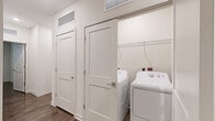 Located on N Nebraska Ave in Tampa, Florida, this single-story, 2-bedroom, 2-bathroom residence offers a thoughtfully designed layout with consistent modern finishes throughout. Wood-style plank flooring runs through the living spaces and bedrooms, creating a cohesive, contemporary aesthetic complemented by neutral wall tones and clean white trim.

The kitchen serves as a central gathering point, featuring stainless steel appliances including a refrigerator, range, and microwave, alongside a granite-topped island, white upper cabinetry, warm wood-toned lower cabinets, and a tile backsplash. Recessed lighting and durable flooring complete the space.

The living area is open and well-lit, providing a comfortable, functional setting. The primary bedroom is generously proportioned and includes a dedicated walk-in closet equipped with wire shelving. Both bathrooms are finished with granite-topped vanities, wood-toned cabinetry, framed mirrors, and tub-shower combinations with white tile surrounds.

Bedrooms feature ceiling fans, windows with blinds for natural light, and easy access to closet storage. A dedicated in-unit laundry area accommodates a full-size washer and dryer side by side, with wire shelving above for additional storage.
