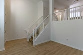 Located at 465 W San Carlos St in San Jose, CA, this modern multi-story home spans four floors and offers 2 bedrooms and 5 bathrooms. Light-toned hardwood flooring flows consistently throughout, complemented by crisp white walls that create a bright, cohesive aesthetic across every level. The entry level features soaring ceilings, large windows that flood the space with natural light, and an attached garage with an automatic opener. Elegant staircases with white spindle railings and warm wood treads connect each floor, with ceiling fans providing comfort in the upper levels. The kitchen is outfitted with stainless steel appliances — including a refrigerator, range, and microwave — paired with two-tone cabinetry featuring white uppers and wood-grain lowers, along with light quartz countertops. The dining and living areas offer open, functional layouts ideal for daily living and entertaining. The bathrooms are finished in a contemporary style, with wood-grain vanities, white quartz countertops, large mirrors, and clean tiled shower-tub combinations. Both bedrooms are well-proportioned and bright, with multiple windows providing natural light and garden views. Additional spaces include a laundry room, multiple closets, and hallways connecting each floor efficiently.