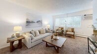 Located at 815 Rice St E in Wayzata, Minnesota, this one-bedroom, one-bathroom unit offers a thoughtfully organized layout across a single floor. The living room serves as the heart of the home, featuring warm neutral carpet, a textured ceiling, and a large window that invites natural light and views of the surrounding greenery. The open feel of the space is complemented by clean white walls, providing a versatile backdrop for a variety of décor styles. A galley-style kitchen runs efficiently along a single corridor, outfitted with white cabinetry, gray laminate countertops, a stainless steel sink, and white appliances including a refrigerator, electric range, and dishwasher. Wood-look flooring adds warmth and durability underfoot. The bedroom is a comfortable retreat, featuring plush carpet, a generous window overlooking mature trees, a ceiling fan, and a built-in closet with louvered doors. The full bathroom is finished with crisp white subway tile in the tub surround, mosaic tile flooring, a white vanity with cabinet storage, and a medicine cabinet, delivering a clean and functional aesthetic throughout. This unit offers a practical and comfortable living space in a convenient Wayzata location.