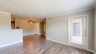 Located at 333 Normandy St in Houston, TX, this single-story, 3-bedroom, 3-bathroom home offers a well-organized layout with a hallway connecting all rooms. The living room is a bright, open space featuring hardwood-style flooring, crown molding, and multiple windows with slatted blinds that allow generous natural light and outdoor views. A direct-access door further connects the living area to the outside. The kitchen is a galley-style space appointed with rich dark cabinetry, light stone-look countertops, hardwood-style flooring, and white appliances including a refrigerator, electric range, microwave, and dishwasher. A peninsula counter with a sink opens the kitchen toward the living area, enhancing the flow between both spaces. Each of the three carpeted bedrooms is outfitted with a ceiling fan and closet; the secondary bedrooms also feature windows with natural views. The primary bedroom is generously sized. The three bathrooms maintain a consistent design language, featuring dark wood vanities with granite-style countertops, large mirrors, and wood-look tile flooring. At least one bathroom includes a full shower-tub combination. The home's neutral color palette and cohesive finishes throughout create a clean, functional, and inviting living environment.