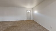 Located at 1652 69th Ave NE in Fridley, Minnesota, this three-bedroom, two-bathroom home spans three floors, offering a well-organized layout suited for comfortable everyday living. The main level features a living room with carpeted flooring and a front entry door with a fan-light window, alongside a kitchen equipped with rich dark cherry cabinetry, granite-style countertops, wood-look vinyl plank flooring, and white appliances including a range and dishwasher. A dining area completes the main living space. Upstairs, three bedrooms provide carpeted comfort, including a generously sized primary bedroom. Dark-toned sliding closet doors and multiple closets throughout ensure abundant storage. Two full bathrooms serve the home, each with a tub-shower combination. The lower level includes a finished bonus room with wood-look flooring and an unfinished basement featuring a painted concrete floor, exposed ceiling joists, and a utility area housing mechanical systems — offering solid potential for future customization. Carpeted staircases with dark wood railings connect all three levels. A patio rounds out the exterior, providing outdoor space. The home's clean, neutral palette and consistent finishes create a move-in-ready environment throughout.
