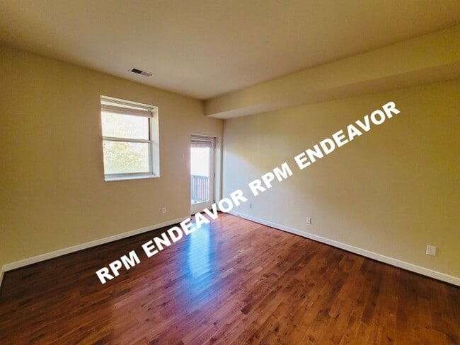 Building Photo - "Charming 2-Bed Condo with Bay Window & Ga...
