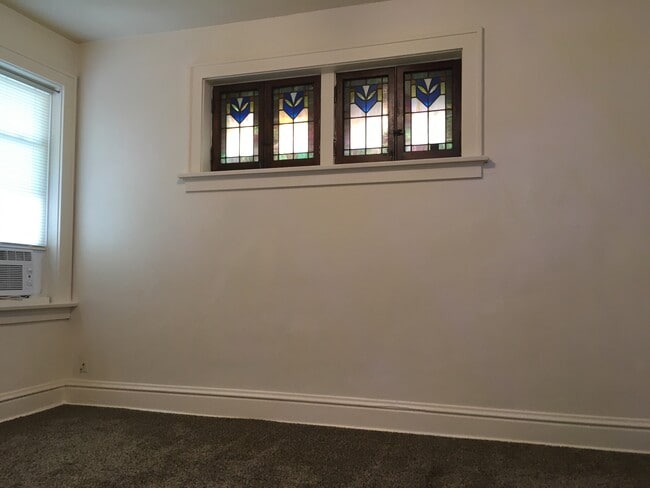 Master bedroom 13 x 12 features stained glass panels and storage closets - 4973 Tholozan Ave