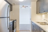 Located at 434 William St in Cobourg, Ontario, this 2-bedroom, 1-bathroom unit offers a well-organized single-floor layout designed for comfortable everyday living. The kitchen features a galley-style configuration with dark cabinetry, stainless steel appliances including a refrigerator and electric range, a stainless sink, and tile flooring — providing an efficient and modern workspace. A ceiling fan adds ventilation and airflow to the space. The living room is bright and open, highlighted by large sliding glass doors that lead to a balcony and allow generous natural light to fill the room. Warm wood-tone flooring runs throughout the living areas and bedrooms, creating a cohesive and inviting atmosphere. Both bedrooms are well-proportioned, featuring sliding glass or panel closets, baseboard heating, and windows with outdoor views of mature trees and the surrounding neighbourhood. The bathroom is clean and contemporary, equipped with a sleek frameless sliding glass shower enclosure with chrome fixtures and tile flooring. Two hallways connect the rooms efficiently, and a dedicated closet provides additional storage. The unit's neutral colour palette and clean finishes make it a versatile and functional living space.