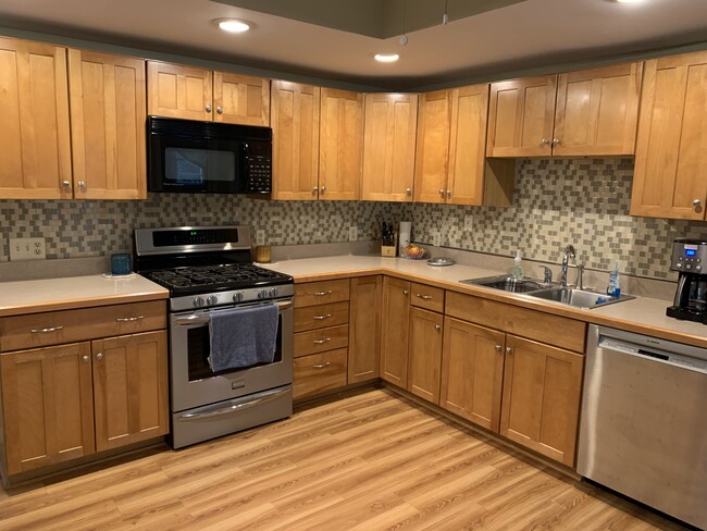 Updated eat-in kitchen with backsplash featuring a large pantry and modern appliances! - 621 Maple Ave