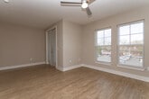 Located at 228 S Main St in Mooresville, NC, this efficiently designed one-bedroom, one-bathroom residence offers a thoughtfully laid-out single-floor living space. Warm hardwood-style flooring flows throughout, complemented by neutral wall tones and clean white trim that create a bright, cohesive aesthetic.

The galley-style kitchen is a standout feature, showcasing stainless steel appliances — including a French door refrigerator, electric range, and built-in microwave — paired with white upper cabinetry, light wood lower cabinets, white quartz countertops, and a herringbone tile backsplash. The sink and fixtures are finished in brushed nickel, adding a modern touch.

The living area benefits from natural light through large windows and is equipped with a ceiling fan. The bedroom offers a comfortable footprint with its own ceiling fan, hardwood-style floors, and a stylish sliding barn door that opens into the bathroom — a charming architectural detail that enhances the modern feel.

The bathroom is clean and functional, featuring a tub-shower combination with white tile surround, wood-toned vanity cabinetry, a white quartz countertop, and brushed nickel fixtures and hardware throughout. The overall design reflects a contemporary sensibility with practical, well-selected finishes.