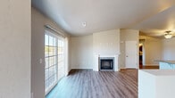 Located at 248 Emerald Blvd in Saukville, WI, this well-designed 2-bedroom, 2-bathroom single-floor home offers a thoughtful layout with comfortable, functional living spaces throughout. The open living area serves as the heart of the home, highlighted by a classic white-mantled fireplace with a granite surround and wide-plank hardwood-style flooring. A large sliding glass door floods the space with natural light and provides outdoor access, while neutral-toned walls create a clean, versatile backdrop. The kitchen is outfitted with white shaker-style cabinetry, granite countertops, stainless steel appliances including a refrigerator, range, and over-the-range microwave, and a functional peninsula ideal for casual dining or meal prep. Both bedrooms feature plush carpeting, ceiling fans, and windows that bring in ample natural light with neighborhood views. Each bedroom benefits from dedicated closet space, including a well-organized walk-in closet with built-in wire shelving. The two bathrooms are finished with granite-topped white vanities and brushed nickel hardware; one includes a walk-in shower, while the other offers a full tub-shower combination. A hallway connects the private areas of the home, completing this clean and move-in-ready layout.