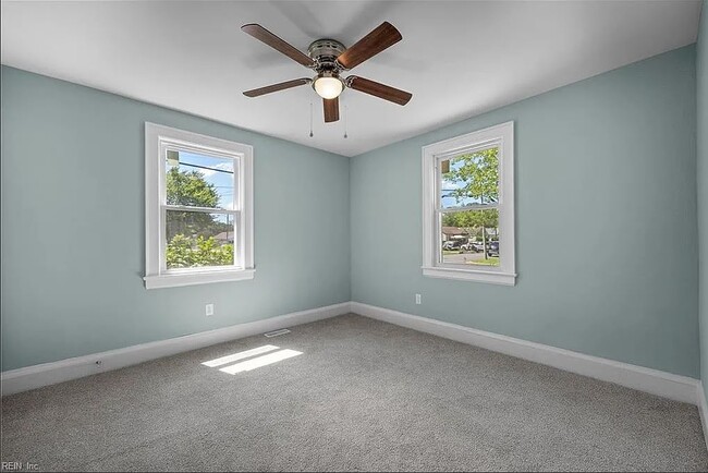 Bedroom with windows and ceiling fan. I added blinds on the windows. - 1003 Douglas Ave House