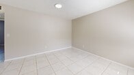 Located at 115 SW 16th St in Pompano Beach, Florida, this single-story, 2-bedroom, 1-bathroom home offers a practical and efficient layout. The interior is finished with light-toned ceramic tile flooring throughout, creating a cohesive and easy-to-maintain living environment well-suited to the South Florida climate.

The combined living, dining, and kitchen area forms the heart of the home. The living room is bright, featuring multiple windows that allow natural light to fill the space, and opens directly to the kitchen. The kitchen is equipped with white cabinetry, a stainless steel electric range, a range hood, and light stone countertops, offering a clean and functional cooking space.

Both bedrooms feature neutral, warm-toned walls, tile flooring, and natural light from windows with blinds. The spacious primary bedroom includes a built-in closet with a rod and shelf system. In total, the home offers three closets, providing ample storage throughout. A hallway connects the bedrooms to the shared bathroom, which includes a full bathtub and shower combination with tiled surround walls.

The textured ceilings are consistent throughout the home, contributing to its classic Florida residential character. This well-organized home presents a straightforward, functional living space in an established Pompano Beach neighborhood.