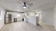 This well-appointed 2-bedroom, 1-bathroom single-story home at 3324 Frontgate Dr in Greenville, NC offers a thoughtfully designed layout with modern finishes throughout. Light-toned luxury vinyl plank flooring runs continuously across the entire home, creating a clean and cohesive aesthetic.

The open-concept kitchen and living area serves as the heart of the home. The kitchen is outfitted with crisp white shaker cabinets, light stone-look countertops, a white subway tile backsplash, and a full suite of stainless steel appliances including a refrigerator, electric range, and dishwasher. A peninsula provides a natural division between the kitchen and living space, while a ceiling fan with integrated lighting keeps the area comfortable.

Both bedrooms are bright and neutrally finished with light walls and matching flooring. The primary bedroom offers a comfortable footprint with ample closet space, while the second bedroom benefits from a window bringing in natural light.

The full bathroom features a tub-shower combination, a vanity with storage, and coordinating finishes. A dedicated utility room provides in-unit washer and dryer hookups. Additional highlights include multiple closets for storage, a patio for outdoor use, and a convenient entry area with natural light.