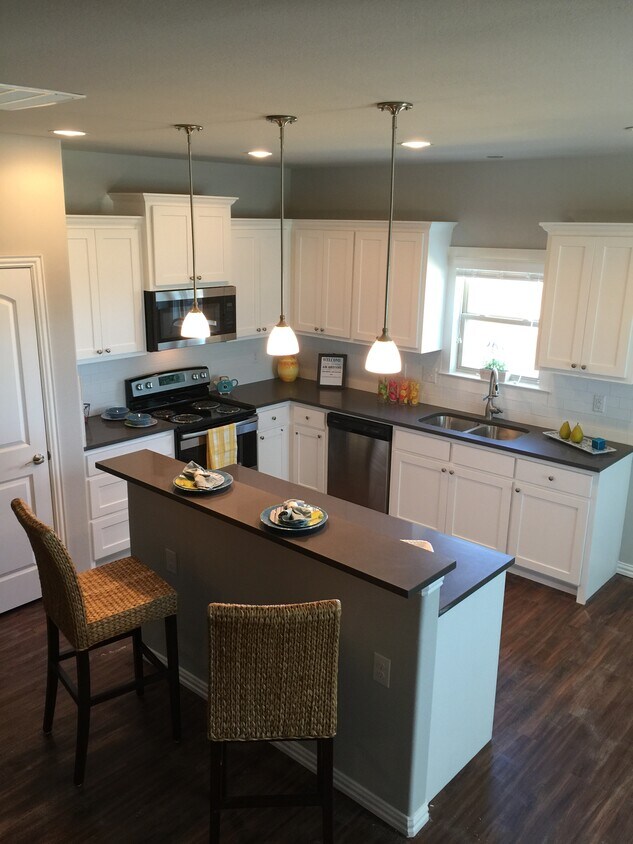 Kitchen with Pantry, Breakfast Bar, and Pendant Lighting - 4926 Villas Drive