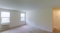 Located at 30 Nutt Road in Phoenixville, Pennsylvania, this single-floor space offers a simple, functional layout designed for comfortable everyday living. The interior features neutral-toned walls and light carpeting throughout, creating a clean and understated aesthetic that provides a versatile canvas for a variety of uses and furnishing styles.

Natural light filters in through windows dressed with vertical blinds, brightening the interior and offering views of the surrounding greenery outside. The rooms are finished with crisp white walls and standard white ceilings, lending a sense of openness and airiness to the space. Baseboard heating units are present along the walls, providing an efficient and consistent heat source throughout the colder months.

The overall ambiance of the space is calm and neutral, with a no-frills design philosophy that prioritizes practicality. The light-toned carpet adds a soft warmth underfoot, complementing the bright walls and contributing to the space's welcoming feel. Situated in Phoenixville, PA, the location offers convenient access to the amenities and community resources of this growing borough in Chester County.