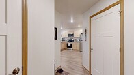 Located at 2040 Maxwell Dr in Hudson, Wisconsin, this thoughtfully designed one-bedroom, one-bathroom unit offers a comfortable and functional single-floor layout. Light wood-style flooring flows throughout, lending a clean, cohesive aesthetic to the entire space.

The open-concept kitchen and living area serves as the heart of the unit. The kitchen is outfitted with light maple cabinetry, stainless steel appliances including a gas range, over-the-range microwave, and refrigerator, as well as a light-colored countertop with a peninsula that provides bar-style seating. A pantry offers additional storage convenience.

The living room is generously sized, featuring a large window that invites natural light, a wall-mounted mini-split HVAC unit, and ample room for both relaxing and workspace arrangements. A sizable closet with double doors adds practical storage directly in the living area.

The bedroom is a comfortable retreat with a ceiling fan, natural light from a window, and enough room for a sitting area alongside the bed. The bathroom is well-proportioned, featuring light wood vanity cabinetry and vinyl flooring. A dedicated laundry area and multiple closets throughout round out the unit's storage offerings, making this a highly practical and livable space.