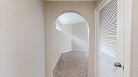 This single-floor, 2-bedroom, 1-bathroom home offers a thoughtfully designed layout with standout architectural character throughout. Vaulted ceilings with ceiling fans elevate the living areas, creating an open, airy atmosphere, while an elegant arched entryway with clerestory window adds a distinctive architectural touch to the hallway.

The generously sized primary bedroom is a true highlight of the home, featuring soaring vaulted ceilings, a large arched window that fills the room with natural light, plush carpeting, and direct access to both a walk-in closet with built-in shelving and a private bathroom. The second bedroom also benefits from vaulted ceilings, a horizontal clerestory window, and an arched niche detail, lending it a unique character.

The kitchen is well-equipped with white cabinetry, granite countertops, a mosaic tile backsplash, and wood-look flooring, complemented by a window that allows natural light to brighten the workspace. The bathroom features a full tub-shower combination with tile surround and wood-look flooring for a clean, functional finish.

Neutral tones, soft carpet in the bedrooms, and consistent design details throughout create a cohesive and welcoming ambiance across the entire home.