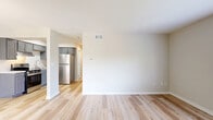 Located at 4653 Refugee Road in Columbus, OH, this one-bedroom, one-bathroom unit delivers a clean, modern aesthetic throughout its efficiently designed single-floor layout. Light-toned luxury vinyl plank flooring flows through the open-concept living and kitchen area, creating a bright and cohesive feel. The kitchen is well-appointed with slate-gray shaker-style cabinetry, light marble-look countertops, stainless steel appliances including a refrigerator, range with hood, and built-in microwave, complemented by a stainless steel sink. The open layout allows the kitchen to connect seamlessly to the living area, offering a functional and welcoming space for daily living. The bedroom features plush carpet flooring and a window overlooking lush greenery, bringing in natural light and outdoor views. One wall features vertical shiplap-style paneling, adding a subtle architectural detail. A door from the bedroom leads conveniently to the full bathroom, which includes a vanity with gray cabinetry, a tub-shower combo, and wood-look tile flooring. The unit also includes two closets for ample storage and a dedicated utility room. The overall palette of warm neutrals and updated finishes gives the space a fresh, move-in-ready appeal.