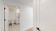 Located at 337-339 Johnston Ave in Jersey City, NJ, this thoughtfully designed one-bedroom, one-bathroom residence offers a clean, modern aesthetic with high-quality finishes throughout. The open-concept kitchen and living area serves as the heart of the home, featuring warm light wood flooring, recessed lighting, and crisp white walls that create a bright and airy atmosphere. The kitchen is well-appointed with white shaker-style cabinetry accented by matte black hardware, a light quartz countertop, a subway tile backsplash, stainless steel appliances including a gas range, built-in microwave, dishwasher, and refrigerator, and a single-basin sink with a sleek black faucet. The bedroom is a serene, light-filled retreat with a large window offering views of the surrounding neighborhood and a wall-mounted HVAC unit for year-round comfort. Two closets provide ample storage. The bathroom is finished in a contemporary style with large-format tile flooring, a soaking tub, a white vanity with a framed mirror, matte black fixtures, and a wall-mounted light bar. In-unit laundry adds everyday convenience, completing this efficiently planned and stylishly finished home.