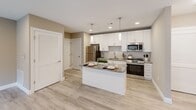 Located at 727 Salem Church Rd in Newark, Delaware, this well-designed one-bedroom, one-bathroom unit offers a thoughtful, efficient layout across a single floor. The open-concept kitchen and living area serves as the heart of the home, featuring crisp white shaker cabinetry extending to the ceiling, granite countertops, a classic tile backsplash, and a full suite of stainless steel appliances including a gas range, built-in microwave, dishwasher, and refrigerator. A central kitchen island with matching granite provides additional prep space and casual seating, illuminated by sleek pendant lighting overhead. Recessed lighting and light-toned walls enhance the bright, airy feel throughout. The living area opens to the outdoors through large sliding glass doors, inviting natural light and outdoor views. Light hardwood-style flooring runs seamlessly through every room, lending a clean, cohesive aesthetic. The bedroom is a comfortable retreat, complete with a ceiling fan, a window with blinds, and a closet. The full bathroom features a tub-shower combination, white vanity with granite countertop, and coordinating flooring. Additional conveniences include in-unit laundry, a utility room, multiple closets, and a hallway connecting all spaces efficiently.