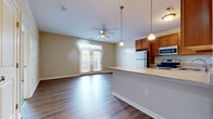 Located at 5102 Water St in Milford, Ohio, this single-floor 1-bedroom, 1-bathroom residence offers a thoughtfully designed open-concept layout with a comfortable and functional flow throughout. The living room is bright and inviting, featuring rich hardwood-style flooring, a ceiling fan, and French doors that lead to a private balcony, allowing natural light to fill the space.

The kitchen is a standout feature, showcasing warm honey-toned cabinetry, granite-look countertops, a decorative tile backsplash, and stainless steel appliances including a range, microwave, and dishwasher. A peninsula counter connects the kitchen seamlessly to the living area, making it ideal for everyday living and entertaining.

The bedroom is generously sized, finished with plush carpeting, a ceiling fan, and a window with natural light. It includes access to a spacious walk-in closet with wire shelving, alongside two additional closets for ample storage throughout the home.

The bathroom features warm wood-tone cabinetry with granite-look countertops, hardwood-style flooring, a tiled shower/tub surround, and direct access to the walk-in closet. A hallway connects all areas of the home efficiently. Neutral tones and consistent finishes create a cohesive, move-in-ready ambiance throughout.