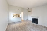 Located at 16822 E Wyoming Cir in Aurora, CO, this single-floor, 2-bedroom, 3-bathroom home offers a thoughtfully designed layout with a bright, clean aesthetic throughout. The open living and dining area is a standout, featuring light wood-look flooring, a ceiling fan, a classic fireplace with a white mantel, and a pass-through window that connects seamlessly to the kitchen. Natural light flows in through multiple windows dressed with blinds, enhancing the airy atmosphere. The galley-style kitchen is well-appointed with gray shaker cabinetry, white subway tile backsplash, white quartz countertops, stainless steel appliances including a refrigerator, electric range, and dishwasher, plus a deep sink with a modern faucet. The bedrooms are carpeted for comfort, each with natural light and generous closet space — four closets total are distributed throughout the home. The bathrooms feature contemporary finishes, including a vanity with gray cabinetry, white countertop, and a glass-enclosed shower in one bath. Additional functional spaces include a laundry room and a utility room. The home's neutral palette and modern updates create a clean, move-in-ready environment.