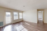Located at 6405 Paddington Ct, Unit 302 in Centreville, VA, this well-appointed 2-bedroom, 2-bathroom unit offers a comfortable and functional single-floor layout. The open combined living and dining area is bright and inviting, featuring durable hardwood-style flooring, neutral-toned walls, a textured ceiling, and multiple windows that allow natural light to pour in. A glass door leads to a private balcony, extending the living space outdoors. The galley-style kitchen is efficiently designed with rich wood cabinetry, light stone-patterned countertops, a stainless steel sink, and appliances including a range and dishwasher, with light wood-style flooring throughout. The spacious primary bedroom features plush carpeting, a natural light-filled window, and direct access to the outdoors, while the second bedroom also offers soft carpet flooring, a closet, and ample natural light. Both bathrooms are cleanly finished, with one featuring a walk-in shower. Four closets throughout the unit provide generous storage, and a dedicated laundry area adds everyday convenience. The unit's clean, neutral palette and well-distributed layout create a practical and comfortable living environment.