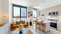 Located at 802 N 1st Ave in the heart of downtown Phoenix, this thoughtfully designed one-bedroom, one-bathroom residence offers a efficient yet well-appointed single-floor layout. The open-concept living, dining, and kitchen area serves as the centerpiece of the home, bathed in natural light from large floor-to-ceiling windows that frame sweeping city skyline views. Light wood-tone flooring runs throughout, lending warmth and continuity to the space.

The kitchen is a standout feature, showcasing light wood cabinetry that extends to the ceiling, white quartz countertops, a subway tile backsplash, and a full suite of stainless steel appliances including a gas range and French door refrigerator. A movable kitchen island doubles as a dining area with bar seating, making the most of the open layout.

The bedroom is a calm, well-lit retreat with recessed lighting, a ceiling fan, and a dedicated closet. The clean white walls and light flooring create a serene atmosphere. The hallway entry is accented with bold wall art, setting a modern tone from the moment you step inside.

The bathroom features a frameless glass walk-in shower adorned with herringbone-patterned tile and a rain showerhead, offering a spa-like experience. A dedicated laundry area adds everyday convenience, completing this intelligently designed urban residence.