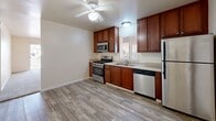 Located at 1125 N Seventh St in Sierra Vista, Arizona, this single-story, 3-bedroom, 2-bathroom home offers a practical and comfortable layout. The kitchen is a standout feature, equipped with rich cherry wood cabinetry, stainless steel appliances including a gas range, microwave, dishwasher, and refrigerator, paired with light countertops and wood-look luxury vinyl flooring. A ceiling fan with light fixture adds airflow and illumination to the space, which also benefits from a window bringing in natural light.

The three bedrooms are carpeted throughout, providing a warm and quiet atmosphere. Each bedroom features built-in closet storage, with some offering sliding or bi-fold closet doors. The bedrooms are bright and well-proportioned, with windows that allow natural light to filter in. The primary bedroom is generously sized, offering ample room for furnishings.

A central hallway connects the living areas to the bedrooms and bathrooms. The two bathrooms are efficiently designed, each featuring a tub/shower combination or stand-up shower, a vanity with sink, and wood-look flooring that complements the rest of the home. Neutral warm tones carry throughout, giving the home a clean, move-in-ready feel ideal for comfortable everyday living.