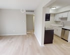 This 790 square foot apartment in Ann Arbor offers a practical and comfortable living space. The single-story layout comprises three bedrooms, including a primary bedroom of 170 square feet, one bathroom, and an open-concept kitchen and living room area. 

The interior showcases a neutral color palette with light gray walls and white trim, creating a bright and airy ambiance. Flooring varies throughout, with plush carpeting in the bedrooms and hallways, and sleek light-colored hardwood in the main living areas and kitchen.

The kitchen features modern white cabinetry, stainless steel appliances, and a functional galley-style layout. The bathroom is equipped with a shower/tub combination, a single vanity, and ample storage space.

Large windows, including a sliding glass door in the living room, allow for plenty of natural light and offer views of the surrounding area. Built-in closets in the bedrooms and hallway provide convenient storage solutions.

The apartment's layout is designed for efficient use of space, with two hallways connecting the various rooms. The overall design creates a cozy yet functional living environment, ideal for individuals or small families seeking a comfortable home in Ann Arbor.