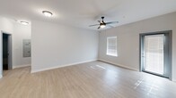 This contemporary apartment in Ooltewah, TN offers 1030 square feet of well-designed living space. The open-concept floor plan seamlessly integrates the kitchen, living, and dining areas, creating a spacious feel. The kitchen is a highlight, featuring sleek dark cabinets, stainless steel appliances, and a striking marble-look countertop with a double sink.

Both bedrooms are generously sized, with the primary bedroom boasting 200 square feet. Each room is equipped with modern ceiling fans and large windows that allow plenty of natural light. The bathrooms are tastefully appointed, with one featuring a tub-shower combination and a dark wood vanity topped with a white countertop.

Throughout the apartment, light-toned wood-look flooring creates a bright, airy ambiance. The neutral wall colors provide a blank canvas for personalization. Ample closet space, including walk-in closets, offers practical storage solutions.

The apartment's design prioritizes comfort and functionality, with features like central air conditioning and heating. The overall aesthetic is clean and modern, making it an ideal space for contemporary living.