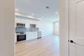 Located at 4225 E Hale Parkway in Denver's desirable Park Hill neighborhood, this thoughtfully designed one-bedroom, one-bathroom residence offers a clean, modern aesthetic throughout. Light-toned hardwood flooring runs continuously across the open-concept living area, creating a warm yet contemporary atmosphere.

The kitchen is a standout feature, showcasing sleek white flat-panel cabinetry extending to the ceiling for ample storage, a herringbone-patterned tile backsplash, and a full suite of stainless steel appliances including a French-door refrigerator, range, microwave, and dishwasher. Recessed lighting throughout the kitchen and living area enhances the bright, airy feel.

The bedroom is a well-proportioned retreat filled with natural light from large windows that frame views of the surrounding Denver cityscape. A ceiling fan adds comfort, and the neutral wall tones complement the light hardwood floors.

The bathroom is finished with large-format tile in the shower/tub surround and on the floor, offering a clean and polished look. Additional conveniences include an in-unit laundry space and a dedicated closet. The unit's modern design, efficient layout, and urban views make it a compelling residence in one of Denver's vibrant neighborhoods.