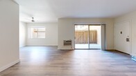 Located at 980 S Menlo Ave in Los Angeles, CA, this 1-bedroom, 1-bathroom unit offers a thoughtfully designed single-floor layout with modern updates throughout. Light-toned vinyl plank flooring flows consistently across the living spaces, creating a clean and cohesive aesthetic. The spacious living area is bright and open, featuring ceiling fans, a wall-unit air conditioner, and a large sliding glass door that opens to a private patio, filling the room with natural light and providing a seamless indoor-outdoor connection. A dedicated entrance leads into the generous living space, which connects to the rest of the unit. The galley-style kitchen is well-equipped with gray shaker cabinetry, white quartz countertops, stainless steel appliances — including a refrigerator, dishwasher, and range — and a deep undermount sink, offering both functionality and style. The bedroom is comfortably sized, featuring a ceiling fan and a dedicated closet with built-in shelving and a full-width hanging rod for ample storage. The bathroom is finished with gray vanity cabinetry, wood-look flooring, and a tub-shower combination enclosed with glass sliding doors, maintaining the unit's modern design language throughout.