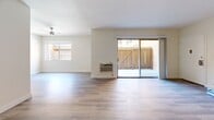 Located at 980 S Menlo Ave in Los Angeles, CA, this 1-bedroom, 1-bathroom unit offers a thoughtfully designed single-floor layout with modern updates throughout. Light-toned vinyl plank flooring flows consistently across the living spaces, creating a clean and cohesive aesthetic. The spacious living area is bright and open, featuring ceiling fans, a wall-unit air conditioner, and a large sliding glass door that opens to a private patio, filling the room with natural light and providing a seamless indoor-outdoor connection. A dedicated entrance leads into the generous living space, which connects to the rest of the unit. The galley-style kitchen is well-equipped with gray shaker cabinetry, white quartz countertops, stainless steel appliances — including a refrigerator, dishwasher, and range — and a deep undermount sink, offering both functionality and style. The bedroom is comfortably sized, featuring a ceiling fan and a dedicated closet with built-in shelving and a full-width hanging rod for ample storage. The bathroom is finished with gray vanity cabinetry, wood-look flooring, and a tub-shower combination enclosed with glass sliding doors, maintaining the unit's modern design language throughout.