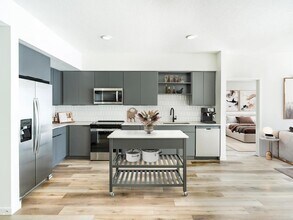 Dark standard kitchen paired with a movable island, bringing flexible style and function to everyday living at Modera Encore in Tampa. - Modera Encore