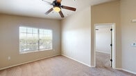 Located at 4649 Loma del Sur Dr in El Paso, TX, this one-bedroom, one-bathroom unit offers a practical and well-organized single-floor layout. The kitchen is equipped with warm oak cabinetry, granite-style countertops, black appliances including a range, microwave, and refrigerator, and hardwood-style flooring. A breakfast bar peninsula connects the kitchen to the adjacent dining and living areas, creating an open, cohesive flow. The living space transitions into soft carpeting, lending a comfortable feel throughout. The bedroom is a well-proportioned retreat featuring plush carpet, a ceiling fan with light fixture, and a window with blinds that allows natural light and outdoor views. Two closets provide ample storage throughout the unit. The bathroom features a wood-toned vanity with granite-style countertops, a framed mirror, and generous cabinet storage. Laundry accommodations are also included within the unit. Neutral tones in beige and warm white are carried throughout, creating a clean and cohesive aesthetic. This unit offers a compact yet complete living experience suited for individuals or couples seeking functional comfort in El Paso.