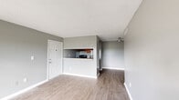 Located at 301 SE 6th Ave in Homestead, Florida, this single-floor, 3-bedroom, 2-bathroom home offers a functional and well-organized layout. The interior is finished with wood-look flooring throughout most of the home, complemented by neutral gray walls and textured ceilings that create a clean, consistent aesthetic.

The living room is a bright, open space featuring a sliding glass door that floods the room with natural light and provides direct outdoor views. The adjacent galley-style kitchen is efficiently designed with warm wood cabinetry lining both sides, a built-in sink, and stainless steel appliances including a refrigerator and range.

The three bedrooms each offer hardwood-style flooring, neutral gray walls, and windows with views of the surrounding landscape. The primary bedroom includes a wide double-door closet with louvered panels, providing ample storage. The additional bedrooms also feature natural light from large windows overlooking open green surroundings.

Both bathrooms are fitted with a tub-shower combination and chrome fixtures, maintaining a simple and practical design. Clean white trim and baseboards run throughout the home, tying the spaces together cohesively. This home offers a straightforward, move-in-ready layout suited for comfortable everyday living.