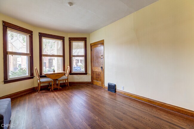 Plenty of windows in the living room with enough space for all your furniture and large tv - 1833 N Harding Ave