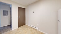 Located at 185 New Ludlow Rd in Chicopee, MA, this single-floor, 3-bedroom, 1-bathroom unit offers a functional and well-maintained layout. The entryway greets you with tile flooring and a baseboard heating system that extends throughout the unit. The updated kitchen features crisp white shaker-style cabinetry, dark granite-style countertops, tile flooring, a skylight, and white appliances including a refrigerator, electric range, and dishwasher. The three bedrooms are carpeted and filled with natural light from large windows, each equipped with wall-unit air conditioning and baseboard heat. The generously sized primary bedroom includes access to a walk-in closet with dual hanging rods, offering ample storage. The full bathroom is finished with tile flooring, a tub-shower combination with white tile surround, a single-sink vanity with white cabinetry, and a mirrored medicine cabinet with overhead lighting. Two hallways connect the rooms efficiently, and the neutral color palette of white walls and beige carpet throughout lends a clean, move-in-ready feel to the entire space.