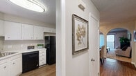 This two-bedroom, one-bathroom single-floor home in Winston-Salem, NC offers a practical and comfortable layout across a well-utilized floor plan. The carpeted living room serves as the heart of the home, featuring a sliding glass door with vertical blinds that opens to an outdoor patio, allowing natural light to flow into the space. A side window further brightens the room, creating an inviting atmosphere.

The kitchen is equipped with white cabinetry, light-toned countertops, black appliances including a range and dishwasher, and a double basin sink beneath a window. Wood-look flooring ties the kitchen and adjacent dining area together seamlessly. The dining room features a ceiling fan, warm neutral walls, and direct sightlines into the kitchen.

The primary bedroom is a comfortable retreat with carpet flooring, neutral walls, and a window with outdoor views. The second bedroom also features carpet and a bright window, offering a versatile space. Both rooms include closet access. The shared full bathroom includes a tub-shower combo, a vanity with storage, and wood-look flooring. A hallway connects all rooms, completing this efficiently designed, move-in-ready home.