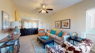 Located at 3540 N Maize Rd in Wichita, Kansas, this single-story, 2-bedroom, 2-bathroom residence offers a thoughtfully designed layout that maximizes comfort and functionality. The open-concept living area features plush carpeting and a ceiling fan overhead, creating a relaxed yet inviting atmosphere. Vaulted ceilings in the living room add a sense of openness and volume to the space. Large windows with blinds allow natural light to filter throughout, brightening both the living and dining areas.

The combined kitchen and dining area is a standout feature, showcasing dark cabinetry with sleek hardware, granite-style countertops, a tile backsplash, and black appliances including a refrigerator, range, and microwave. Pendant lighting illuminates the kitchen island, which doubles as a breakfast bar with barstool seating. The adjacent dining area features wood-look flooring and a sliding glass door that lets in additional natural light and outdoor views.

Both bedrooms are carpeted and well-proportioned, with the primary bedroom offering generous closet space. The bathrooms are finished with dark vanity cabinetry, granite-style countertops, and wood-look flooring. Three closets and a dedicated laundry room add practical storage throughout. The hallway connects all rooms efficiently, rounding out this well-organized and stylish home.