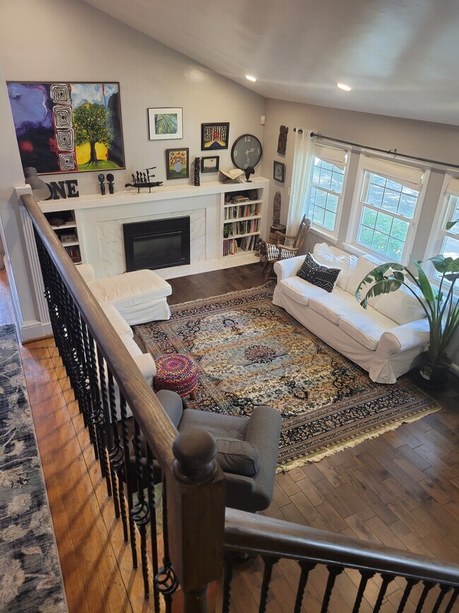Look down to living room with custom built design. - 2907 64th Ave